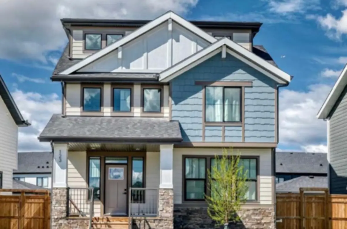 123 Harmony Circle, my listing: two-storey craftsman-style house with blue siding and a front porch in Harmony, Springbank